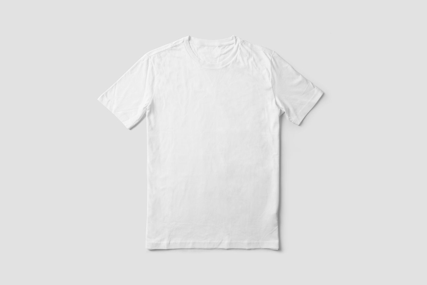 A blank tee, flat-lay, on a light neutral background