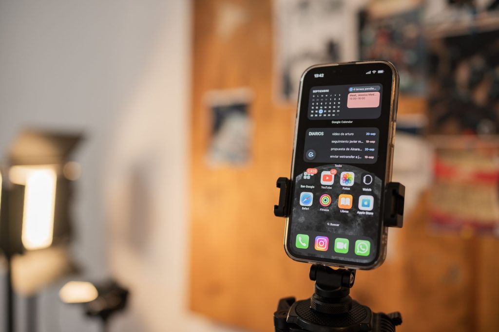 A smartphone on a tripod in a content creation setup