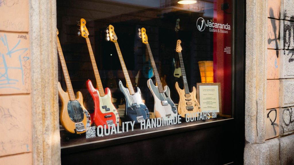 A shop window displaying handmade guitars