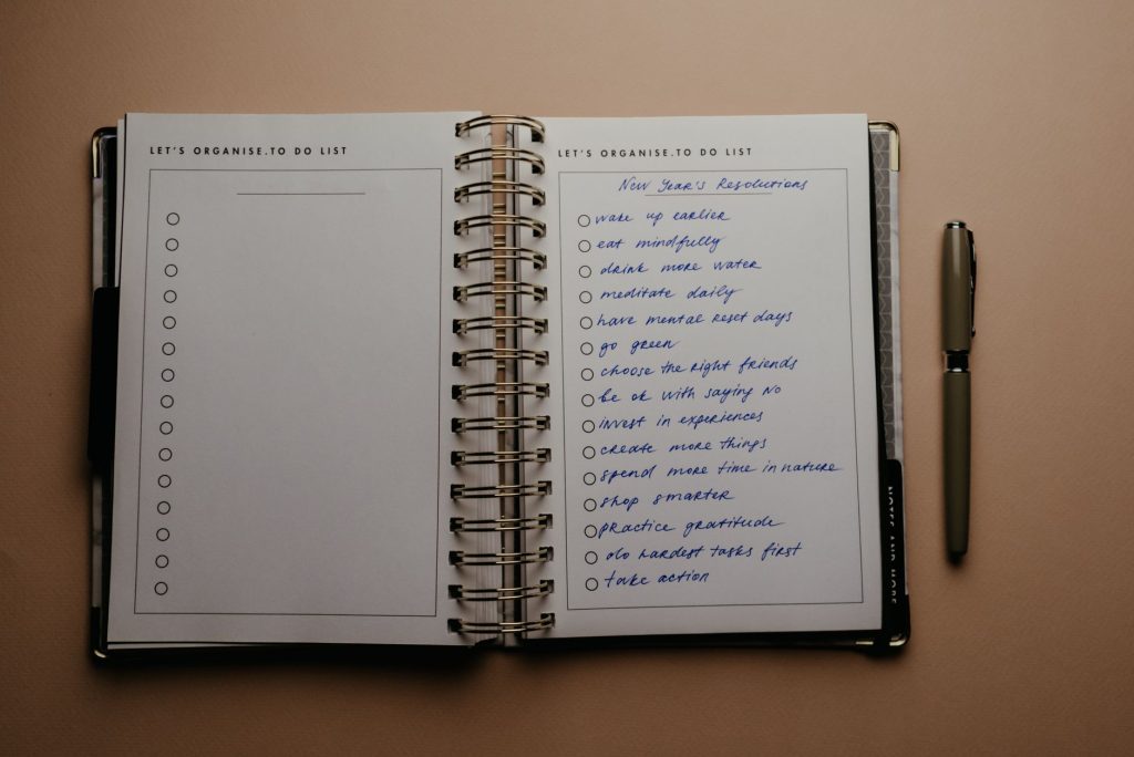 An open planner with a handwritten habit checklist